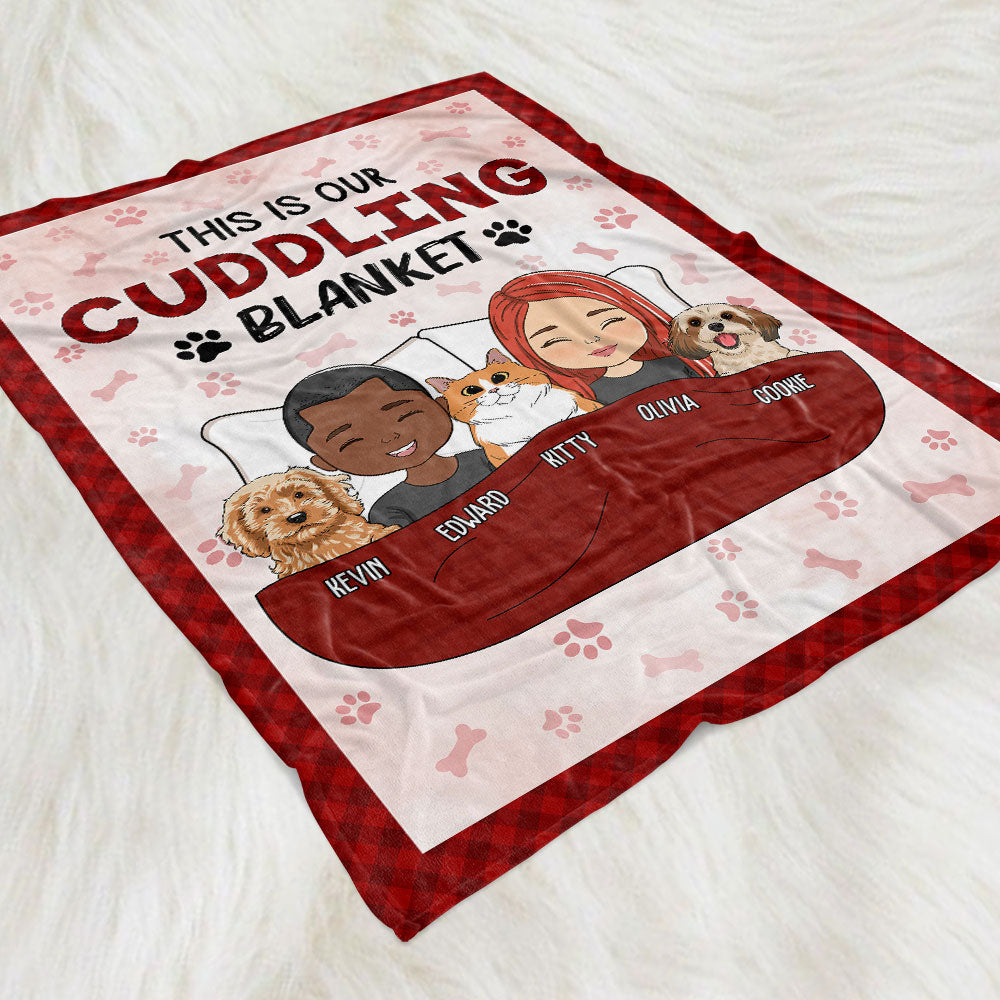 Personalized Couple Cuddling Blanket on white background with text 'This is our cuddling blanket' and cartoon couple and pet.