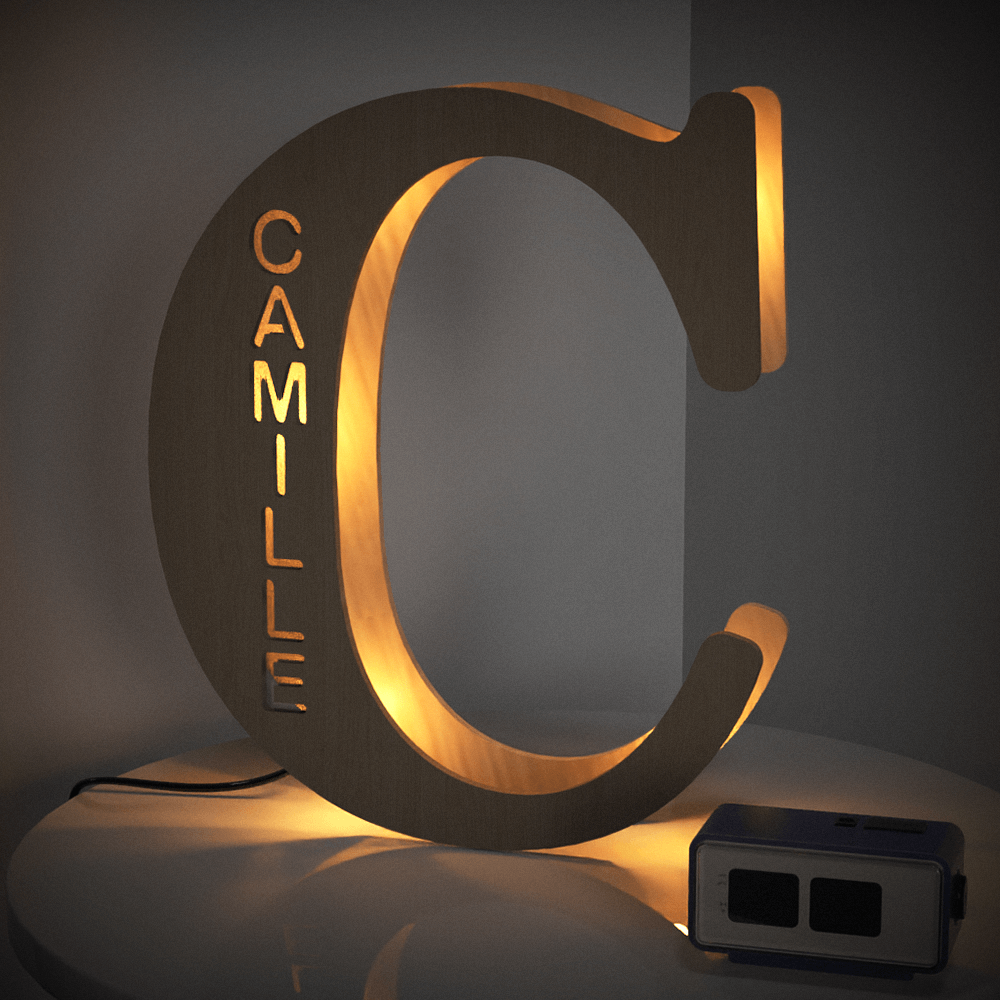 Personalized wooden letter "C" night light with engraved name "CAMILLE", emitting a warm glow, 19CM.